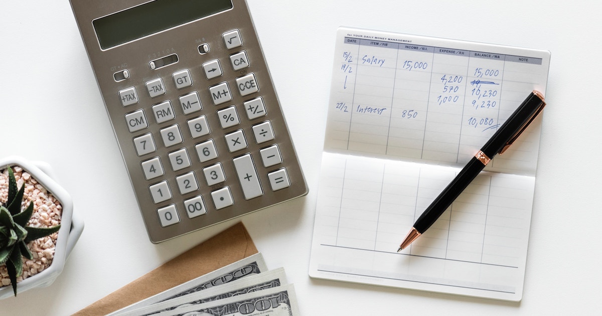 budgeting with pen, paper and calculator